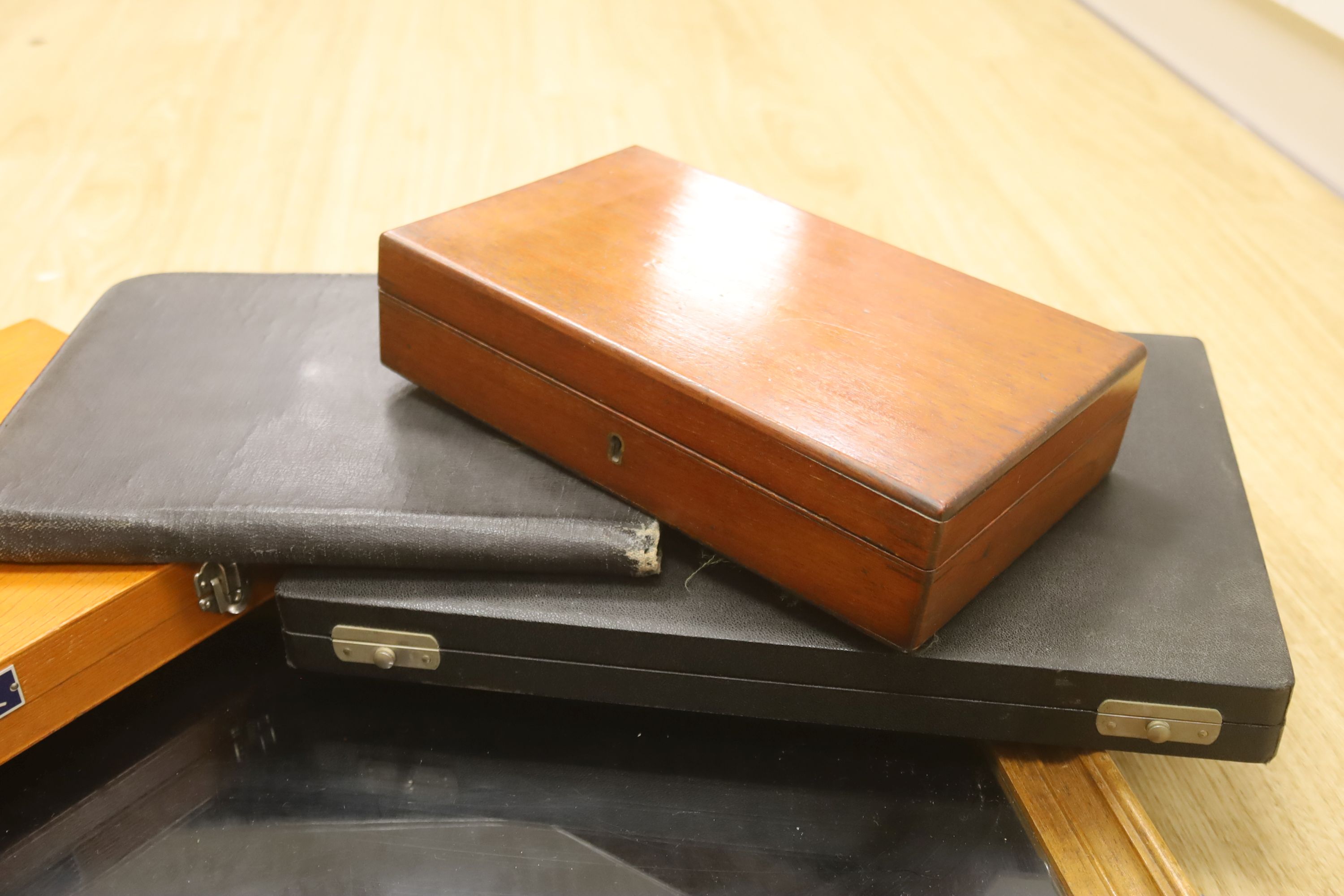 A glass table top cabinet and a collection of pen boxes